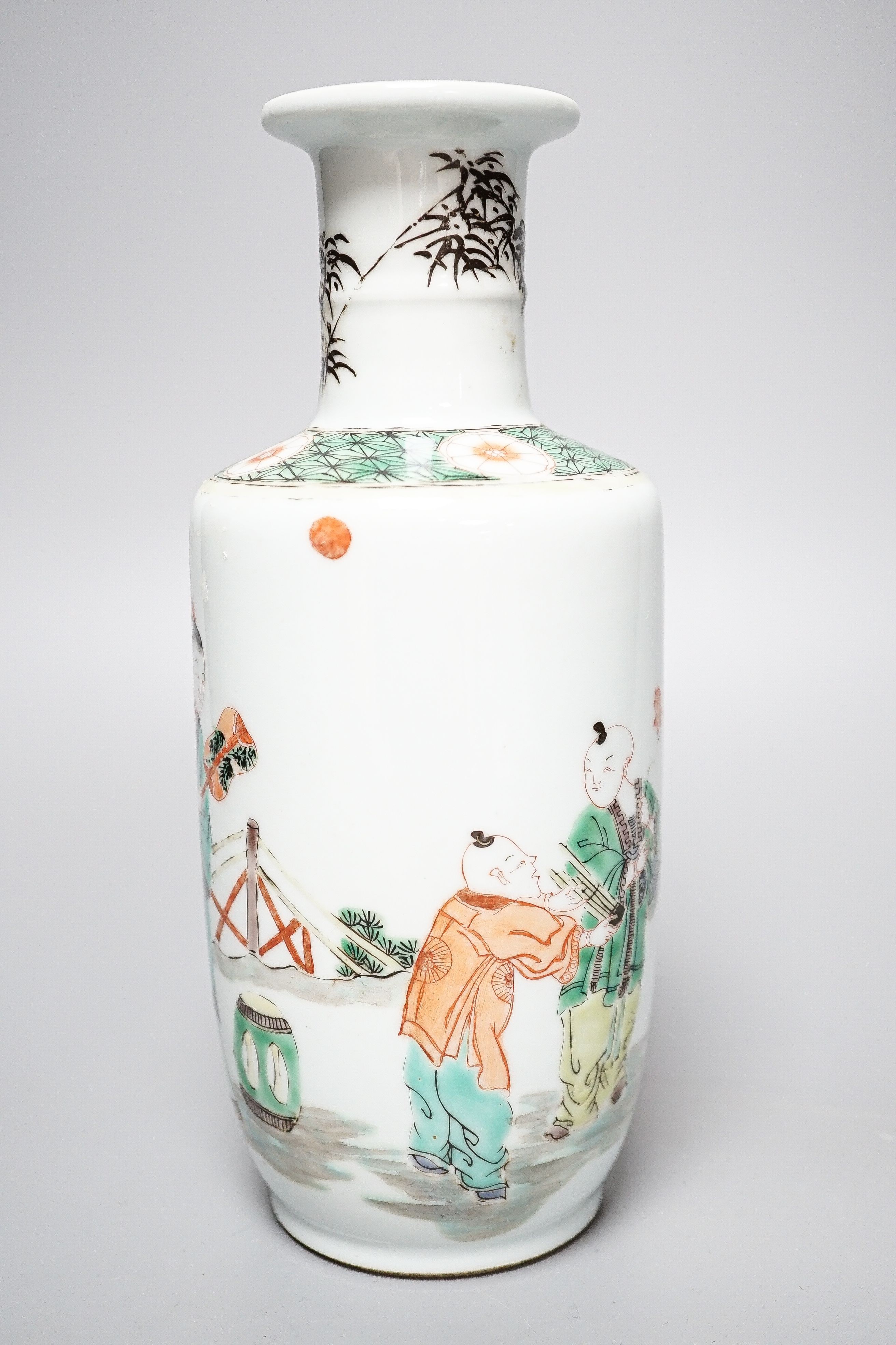 A Chinese famille verte rouleau vase, painted with figures in a garden, 22cm